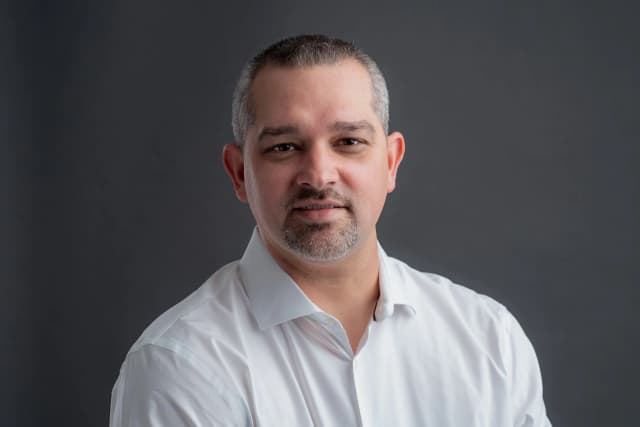 Professional headshot with clean background and natural lighting